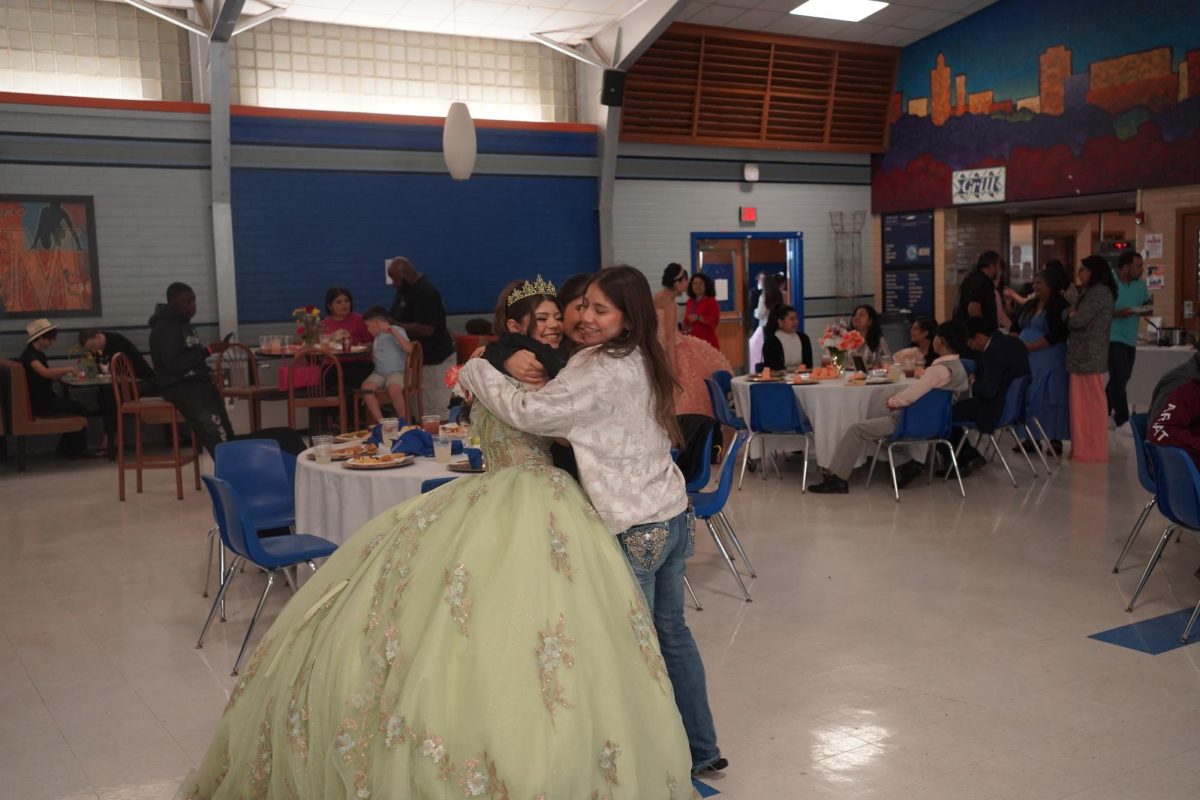 Quinceañera Envy Flores hugs her friends after performing the waltz at the Quince.