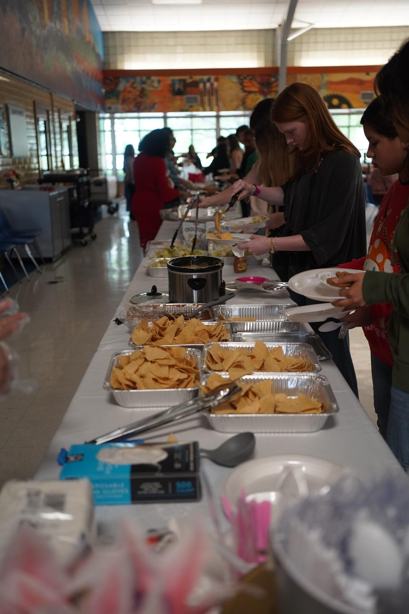 Guests lined up and getting food at the Quinceañera.