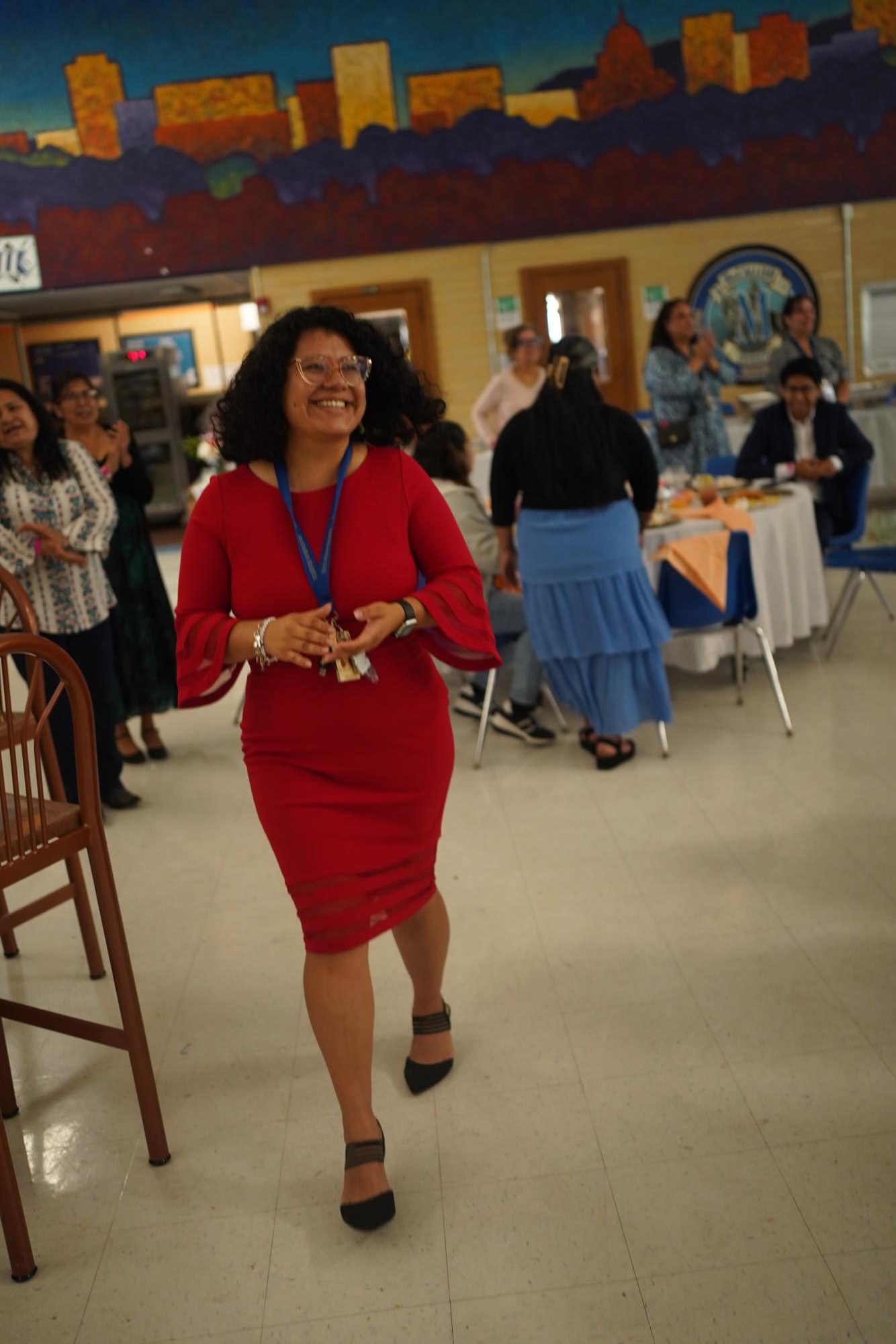 Señora A laughs and claps while walking. 