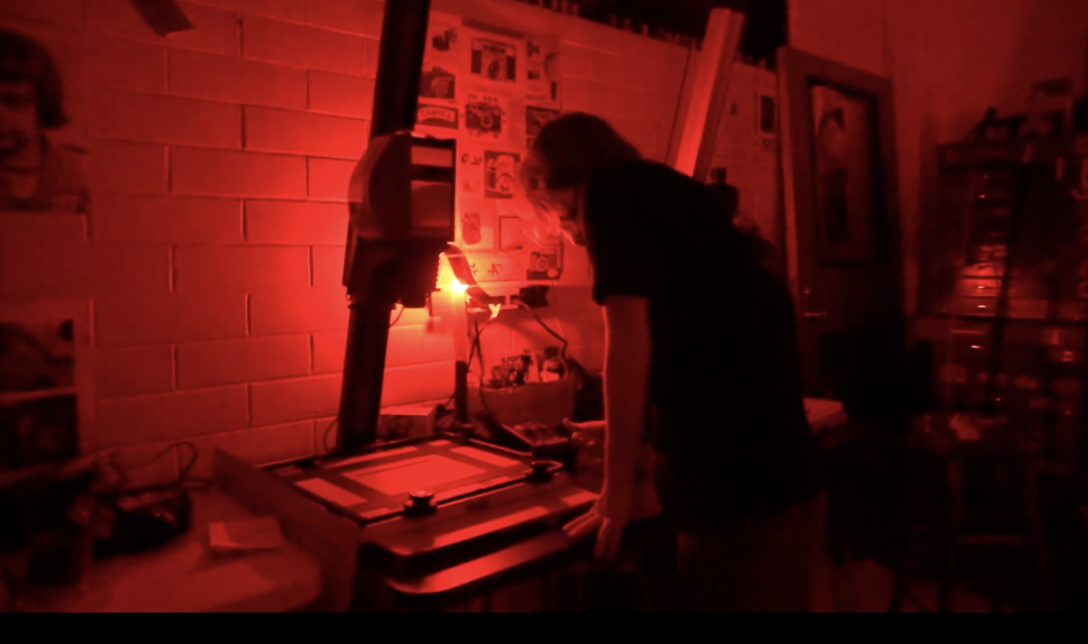 Senior newspaper student Lucas Walker in the darkroom.